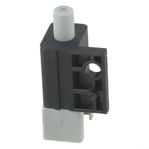 Black and gray plunger safety switch replacement part for CADET mowers, plastic material, shown from angled view.