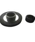 Front view of motor brake components: large black flange with splined inner bore and small knurled ring