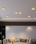 10 Pack Slick Brass Led Downlights With 10W Dimmable Eyeball Spotlight For Smooth Recessed Lighting Upgrades Tool Free Retrofit Kit illuminate a modern living room ceiling.