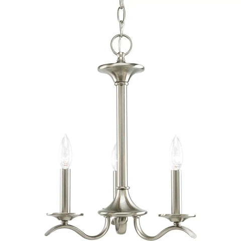 Silver light fixture with three candle bulbs, Inspire Collection 3 Light Chandelier In Antique Bronze With Waving Metal Arms And Off White Linen Shades, Ceiling Chain Mount With 6 Foot Chain, Rustic Modern Vibe For Dining Room Or Foyer Lighting.