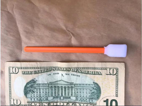 Foam cleaning swab with orange handle and white foam tip, 5.11 in, for electronics/cameras; 1 swab and 1 $10 bill shown