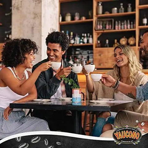 Group of friends enjoying coffee in a cafe, smiling and conversing around a table, showcasing Yaucono branding.