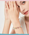 Woman wearing bracelet with Colorful Acrylic Cat Beads Kit 100 Pcs, Cute 3D Cat Face Spacers for jewelry making and DIY crafts.