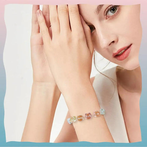 Woman wearing bracelet with Colorful Acrylic Cat Beads Kit 100 Pcs, Cute 3D Cat Face Spacers for jewelry making and DIY crafts.