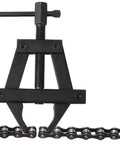 Close-up of Shop Grade Motorcycle Chain Tensioner Tool Badass Heavy Duty Steel Chain Adjuster Wrench over motorcycle chain.
