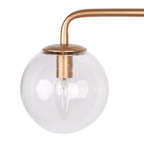 Close-up of a seeded glass shade from the Black And Gold Three Light Vanity Light Fixture With Seeded Glass Shades And Black Backplate
