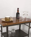 Heavy Duty Metal Industrial Rolling Cart With Three Roomy Shelves For Kitchen Storage Bar Setup And Home Organization Top Shelf with drinks and glassware.