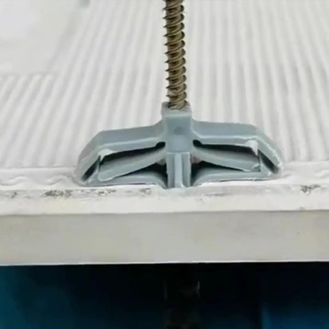 Close-up of a butterfly nylon expansion anchor from 400Pcs Self Drilling Wall Anchors Kit with internal threads in drywall.