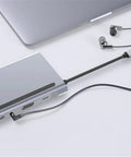 Slick 12 In 1 Type C Hub Docking Station With Crisp 4K Display Dual Gigabit Ethernet Lan Ports PD Quick Charge Aluminum Body connected to laptop.