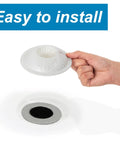 Hand holding a Drain Cover Hair Catcher For Shower And Bathtub 3 Pack That Keeps Hair Out And Prevents Clogs While Letting Water Flow Freely