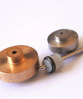 Close-up of copper and steel valve discs with nozzle from OmniJet III water jet repair kit