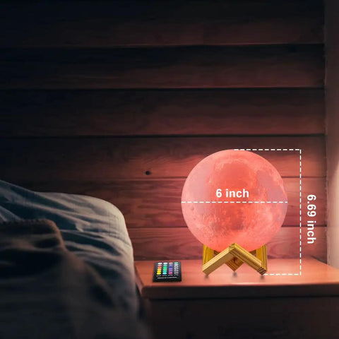 Lit Moon Lamp 3D Printed LED Night Light With 16 Color RGB Modes Remote And Touch Control Adjustable Brightness USB Recharge Realistic 6 Inch Moon Decor For Kids And Birthday Gift. Shown lit on a bedside table with remote control.