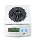 9 Speed Bike Cassette 11-25T 11-32T 11-36T 11-40T for mountain and road bikes on electronic scale showing 342.5 grams.