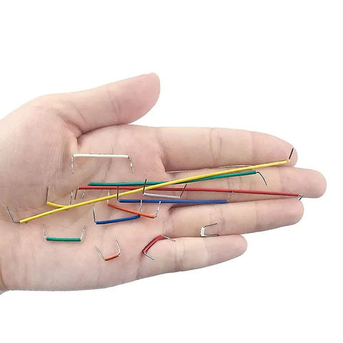 Hand holding 560 Piece Breadboard Jumper Wires Set For Arduino And Electronics, 24 AWG U Shaped Male To Male Cables in various colors.