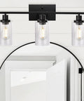 Three Light Matte Black Farmhouse Vanity Light With Seeded Glass Wall Sconce above bathroom mirror