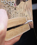 Close-up of Wooden Ring Clamp Tool Set, 2Pcs Jewelry Wire Clamp For Ring Bending And Polishing in use, showing wood vise.