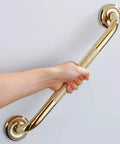 Person holding Textured Shower Grab Bar 16 Inch Bathroom Support Rail With Polished Brass Finish Stylish Safety Armrest Hand Rail