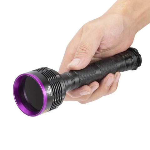 Hand holding Beast Mode 20W 365nm UV Flashlight With USB Rechargeable Battery Battery Included Black Light.