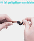 Hands holding black silicone Anti Slip Eyeglass Ear Grips Set With Soft Silicone Retainers For Glasses, Sunglasses, And Specs