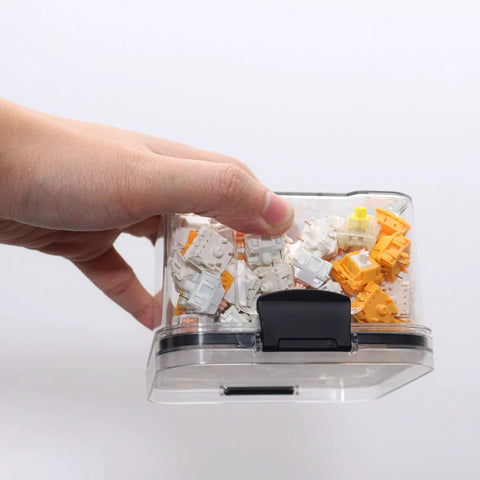 Side view of transparent plastic Sumgsn keyboard switch storage box (460ml) filled with white and orange switches.
