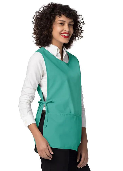 Heavy Duty Cobbler Apron 3 Pack For Men And Women In Bold Surgical Green with deep pockets, worn by a smiling woman.