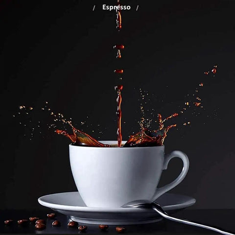 Splash of espresso pouring into white cup on saucer with coffee beans and spoon, illustrating brewing process for cafe-quality shots.