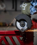 Norton 4-1/2-inch cut-off wheel front view on angle grinder cutting metal with sparks; red workbench in background