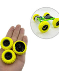 Hand holding yellow 10Pcs RC Toy Car Wheels with Rubber Tires and 5Pcs Metal Shafts, shown on an assembled RC car model.