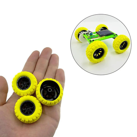 Hand holding yellow 10Pcs RC Toy Car Wheels with Rubber Tires and 5Pcs Metal Shafts, shown on an assembled RC car model.