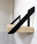 Heavy Hitter Iron Corner Brackets For Floating Shelves built tough supporting a wooden shelf in matte black finish.