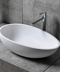 Real Deal White Oval Vessel Sink Built Tough From Dense Artificial Stone For Quick Countertop Installation With A Slick Finish That Stays Bright Through Years Of Heavy Bathroom Traffic on vanity with faucet.