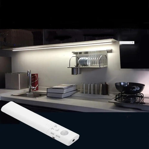 9.8ft Under Cabinet LED Strip Lights With Motion Sensor And Battery Power Auto Or Manual Modes Ideal For Closet Kitchen Bedroom Stairs Basement Trunk And More White 4000K illuminating a modern kitchen countertop with control remote
