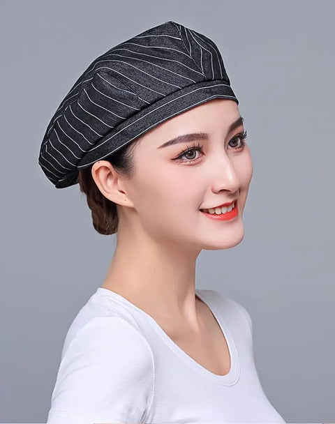 Custom Logo Chef Beret And Barista Hat For Kitchen Crew Offering Breathable Embroidered Name Cook Skullcap In Sleek Black Slick Go To Food Service Gear worn by model, profile view.