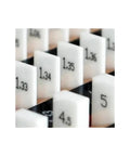 Close-up of numbered 1.33 to 1.36 ceramic gauge blocks for precision calibration of micrometers and calipers.