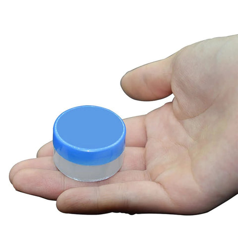 Small container of White Lithium Grease for Machinery and Gears, High and Low Temperature Resistance held in hand
