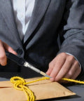 Afantti 31 Piece Electric Hot Knife Foam Cutter Kit used to cut yellow rope on a package for precise application.