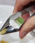 Close-up of hand using Easy Pineapple Eye Clip And Peeler Kit with stainless steel cutter for pineapple slicer and seed remover