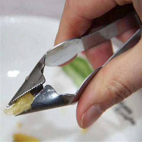 Close-up of hand using Easy Pineapple Eye Clip And Peeler Kit with stainless steel cutter for pineapple slicer and seed remover