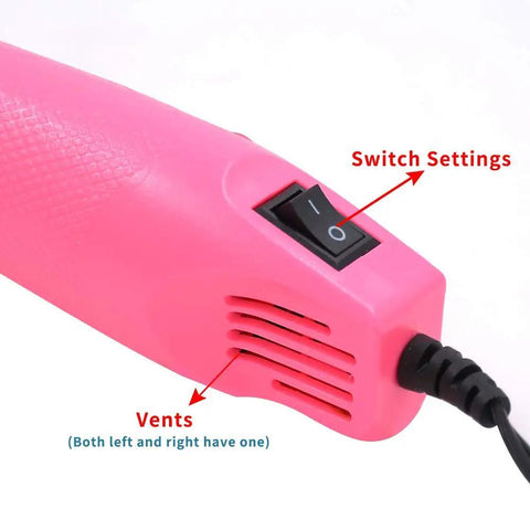 Close-up of pink Mini 300W Heat Gun With Stand For DIY Embossing Shrink Tubing And Drying Paints Multi Purpose Hot Air Tool handle