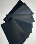 Super Versatile 90 Pcs Sandpaper Assortment Ranging From 400 To 3000 Grit Wet Dry Sheets showing black sheets for wood, metal, and glass.