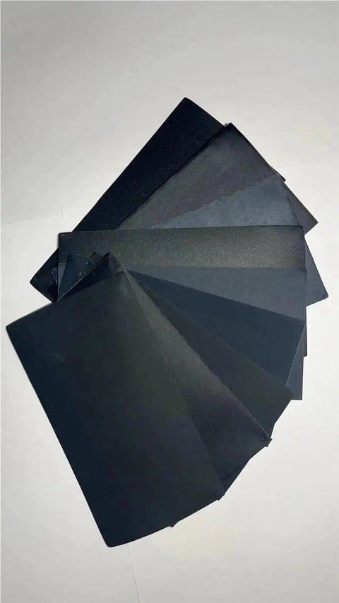 Super Versatile 90 Pcs Sandpaper Assortment Ranging From 400 To 3000 Grit Wet Dry Sheets showing black sheets for wood, metal, and glass.