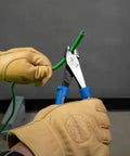 Person using Heavy Duty 8 Inch Diagonal Cutting Pliers With High Leverage Design Made In USA Workhorse Tool on green wire.