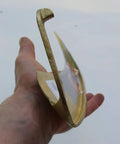Close-up of hand holding Hand Forged Austrian Scythe Blade With 23.5 Inch Length Dual 50mm And 55mm Sweeps Sharp And Ready To Use