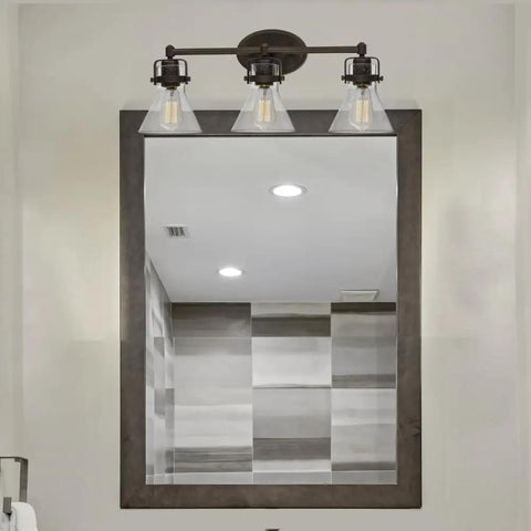 Seafarer 3 Light Bath Vanity Light In Oil Rubbed Bronze Steel Finish With Seeded Glass Shades over bathroom mirror
