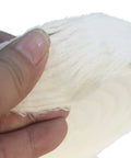 Close-up of a hand holding a Two Pack Beefy Extra Thick White Cotton Buffing Wheels Eight Inch Diameter with Five Eighth Inch Arbor Hole