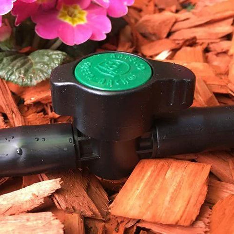 Habitech inline barbed ball valve for 3/4 inch tubing; black plastic with green cap, front view