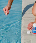 Person using Six Way Pool Water Test Strips For Rapid Chemical Readings With Seamless App Sync to test pool water.