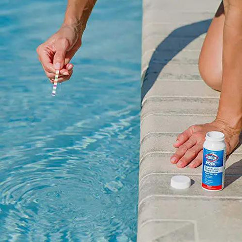 Person using Six Way Pool Water Test Strips For Rapid Chemical Readings With Seamless App Sync to test pool water.