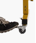 Foot pressing on caster of Heavy Duty Expandable Metal Barricade Gate For Crowd Control And Traffic Jobs No Sweat.