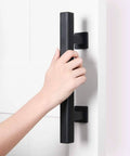 Person gripping two pack 12 inch barn door handles set with rustic two side pull and flush sliding design in black square finish.